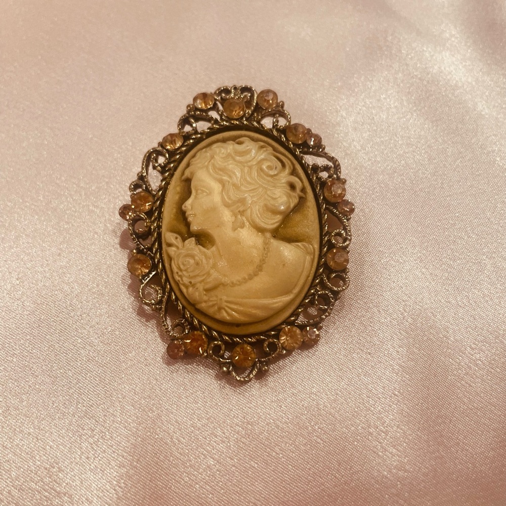 Vintage costume cameo with filigree and crystals is a broach pin jewelry brooch